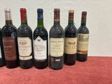 several bottles of wine are lined up in a row on a table