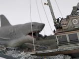 a model of a boat with a shark on top of it