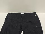 the shorts are black and have buttons on the side