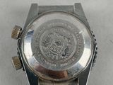 a close up of a watch on a white surface