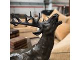 bronze sculpture of a stag with antlers on it ' s head