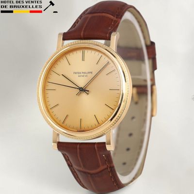 an image of a close up of a watch on a white surface