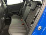 the back seats of a blue car with a black seat belt