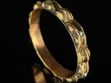 a close up of a gold ring on a black surface