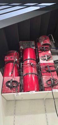 many red fire hydrants in the back of a truck