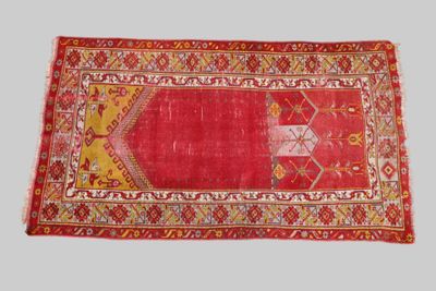 a red rug with a yellow and red design on it