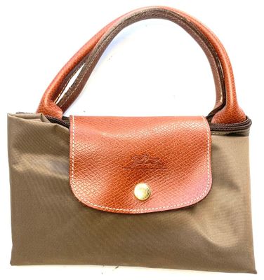 an image of a brown and tan purse on a white background