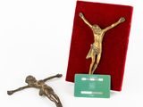 a statue of jesus on the cross next to a credit card