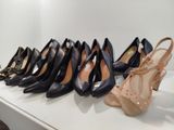 several pairs of women ' s shoes are lined up on a shelf