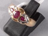 an image of a gold ring with two ruby stones