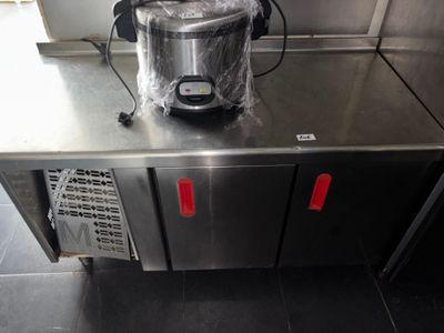 stainless steel counter top with a blender on it in a commercial kitchen