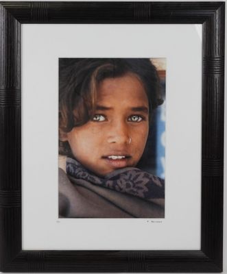 portrait of a young girl with blue eyes in a black frame