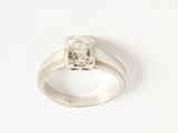 a close up of a diamond ring on a white surface