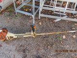 a chainsaw that is laying on the ground next to a chair