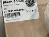 a box with a black button on it sitting on a table