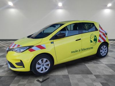 the yellow car is parked in the garage with a checkered floor