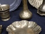 a lot of brass items that are on a table
