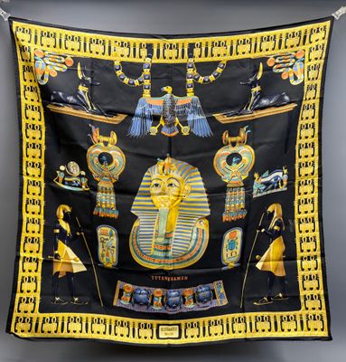 a black and yellow scarf with egyptian symbols on it