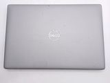 dell laptop computer sitting on a white surface with the dell logo on the screen