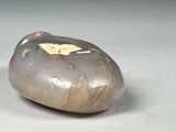 pair of carved rocks sitting on top of a table next to each other