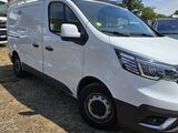 the white van is parked in a lot with other vehicles in the background