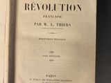 an open book on a table with the title of a revolution