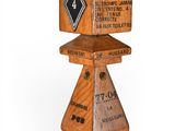 a wooden block with a sign on top of it