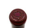 a close up of a bottle of wine on a white surface