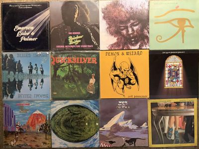 many different album covers on the wall of a room