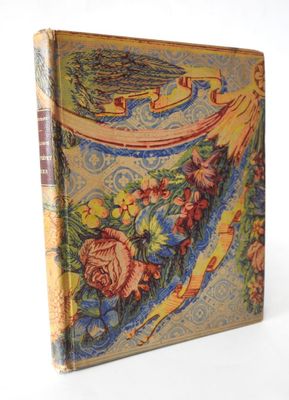 a close up of a book on a white surface with flowers
