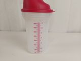 a plastic cup with a red lid on a white table