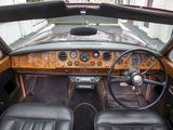 a car dashboard with leather seats and a steering wheel