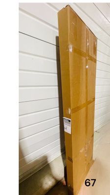 a large stack of cardboard boxes sitting on top of a wooden floor