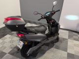 a scooter parked in a room with a checkered floor