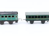 three toy trains that are lined up on a white surface