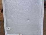 a refrigerator that is sitting on the floor in a room