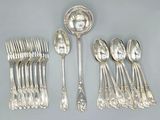 a lot of silver spoons and spoons on the table