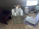 a glass table with bottles of lotion on it in a room
