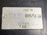 a metal plate with a number on it on a table