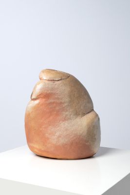 a small sculpture on a white pedestal on a white surface
