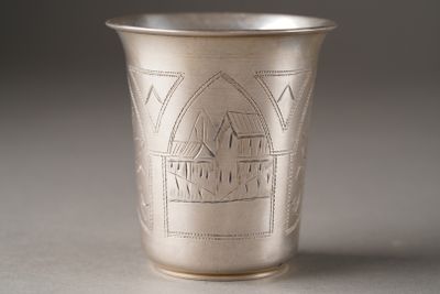 a silver cup that has a design on it