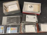 many different types of envelopes in a box on a table
