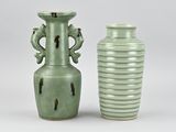 two green vases sitting next to each other on a table