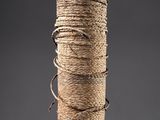 rope wrapped around a wooden pole on a gray background