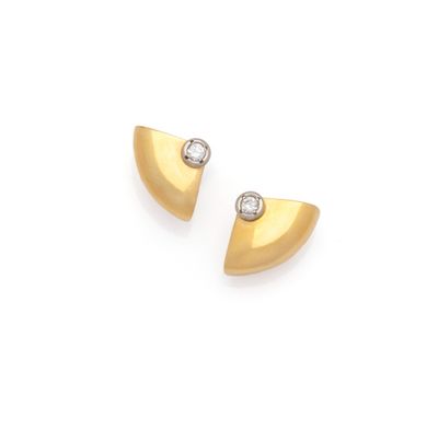 a pair of gold and diamond earrings