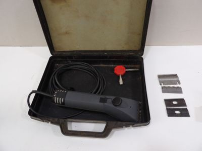 a black case with a black cord and a red button