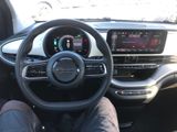 someone is sitting in the driver ' s seat of a car with their feet on the steering wheel