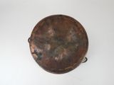 an old copper plate with a handle on it