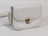a white purse that is sitting on a white table