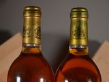 two bottles of wine sitting next to each other on a table